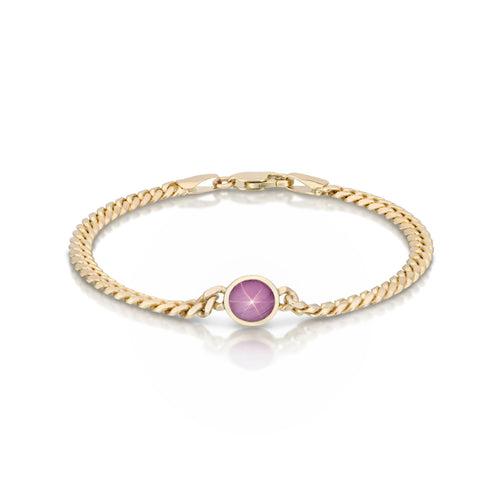 Crafted in 14k yellow gold and set with a star ruby, this 7” bracelet reveals a glowing six-ray star when light is shined on it.