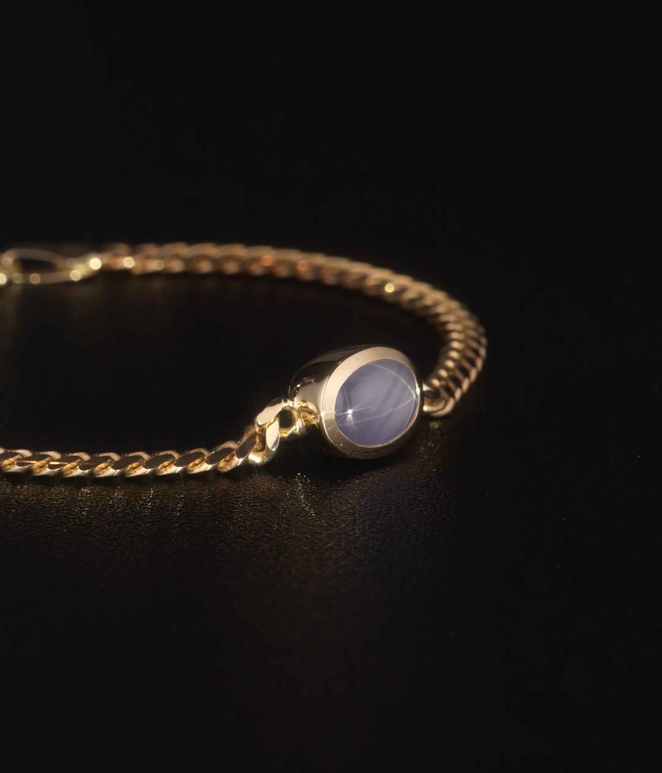 Crafted in 14k yellow gold and set with a star sapphire, this 7” bracelet reveals a glowing six-ray star when light is shined on it.