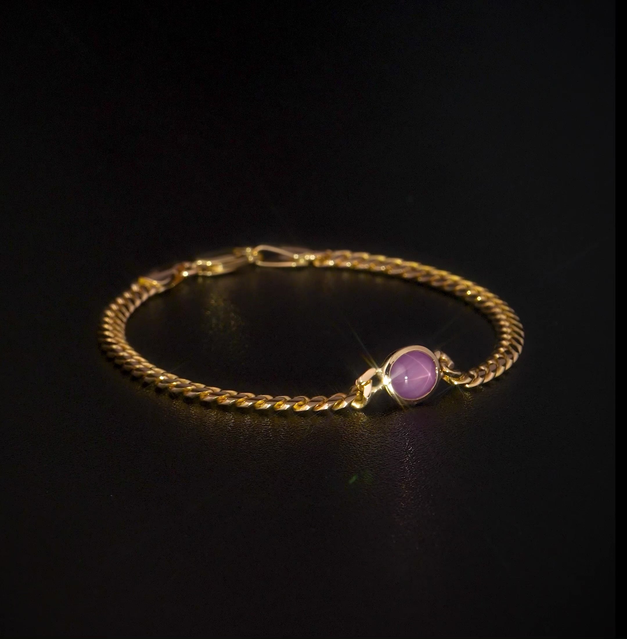 Crafted in 14k yellow gold and set with a star ruby, this 7” bracelet reveals a glowing six-ray star when light is shined on it.